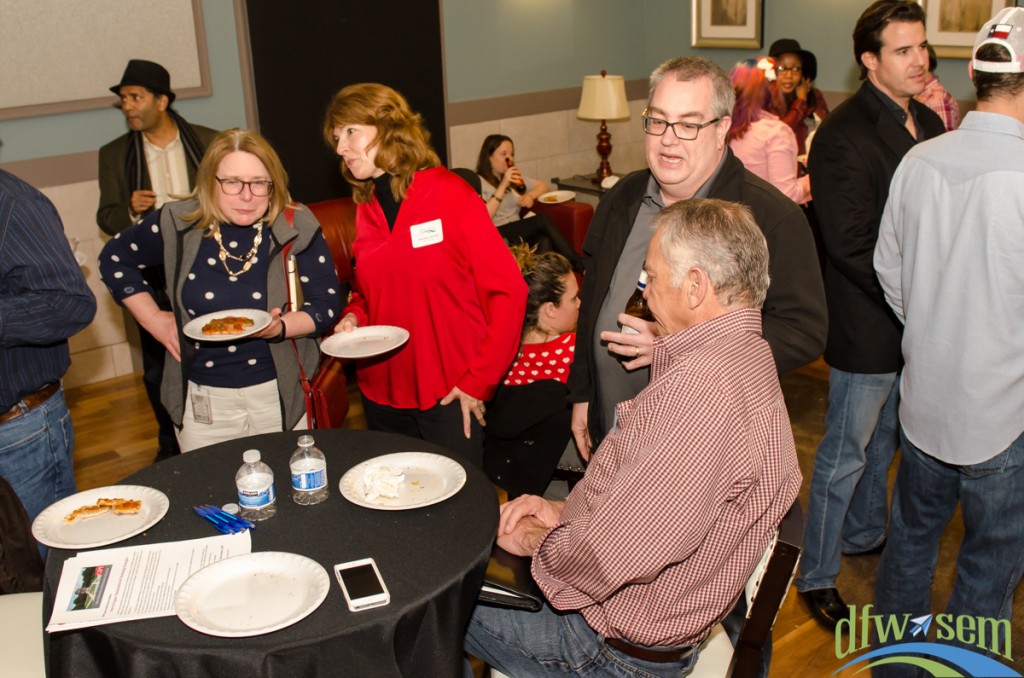Laurie Shook and Christine Churchil enjoy pizza and a chat during post-presentation networking.